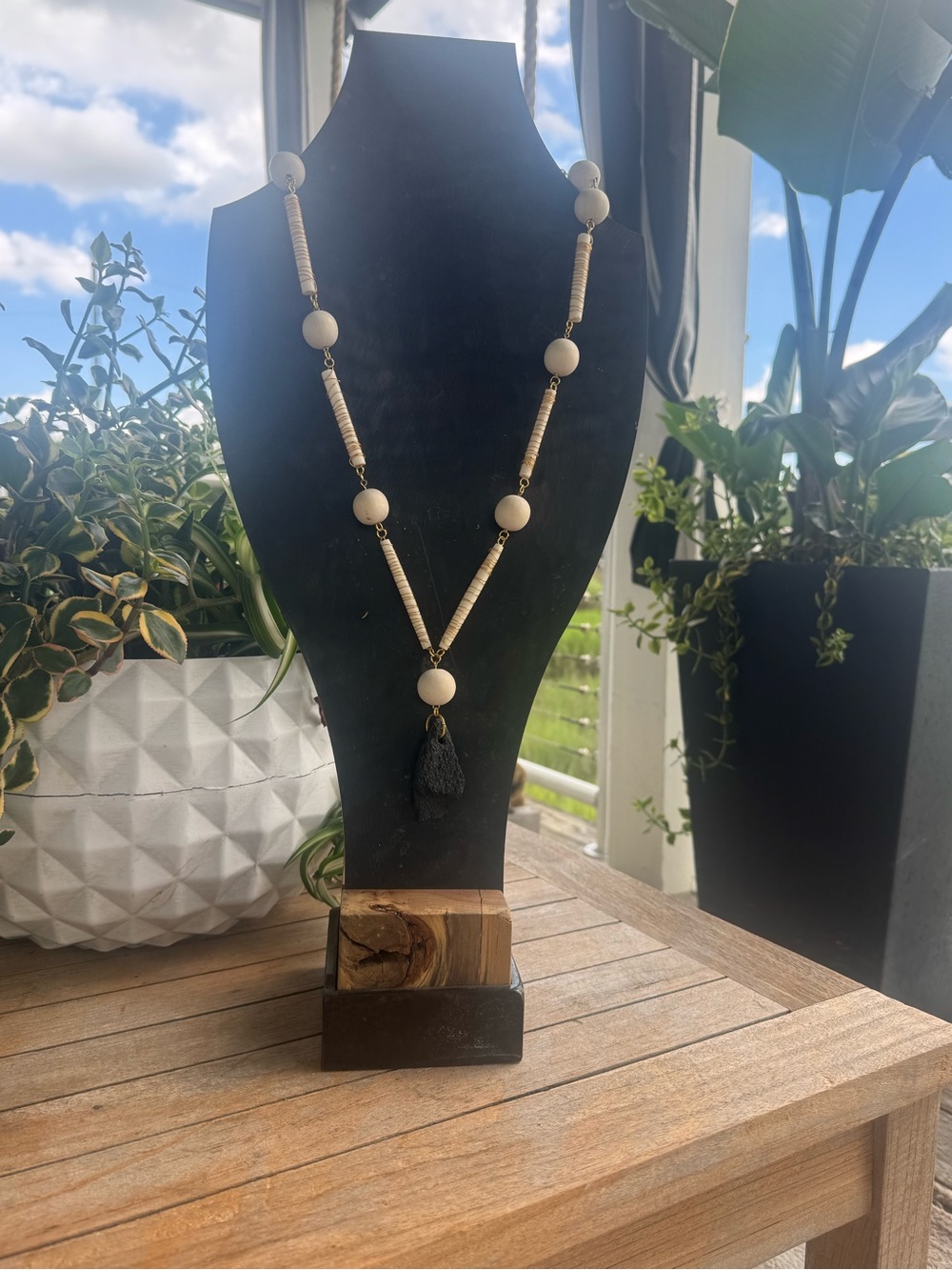 Cream Bone and Wood Bead Necklace with petrified piece of bone pendant.